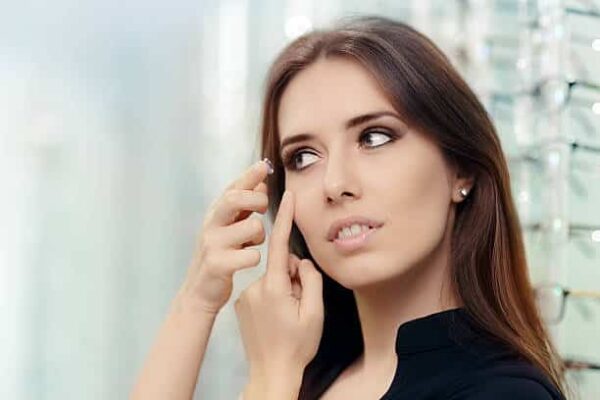 close up of a girl trying on beauty medical contact lenses