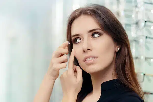 close up of a girl trying on beauty medical contact lenses