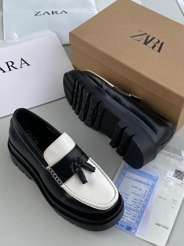 men’s tasseled black and white loafers