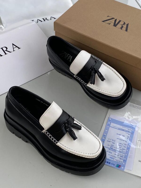men’s tasseled black and white loafers
